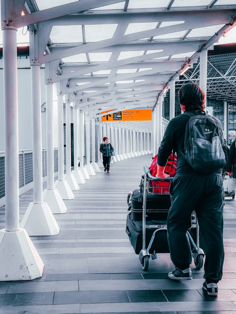 travelers at airport terminal walking confident because he got covered by travel insurance